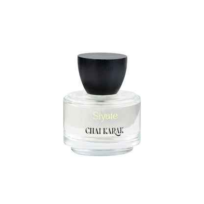 Perfume bottle with black cap and white body on a white background